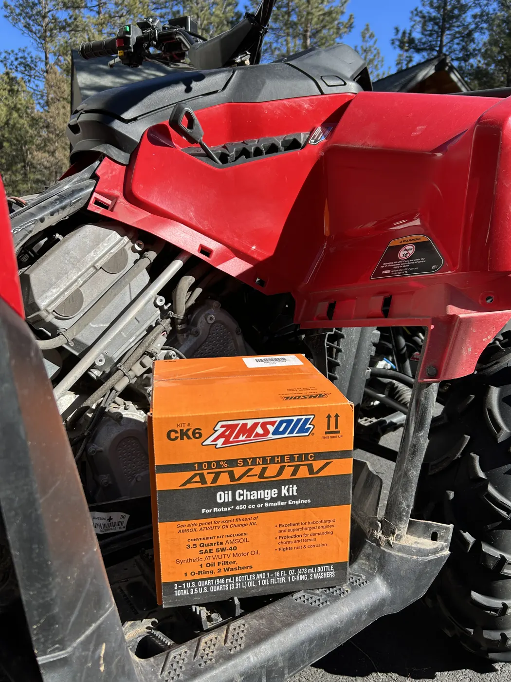 AMSOIL ATV/UTV Oil Change Kit on a red ATV